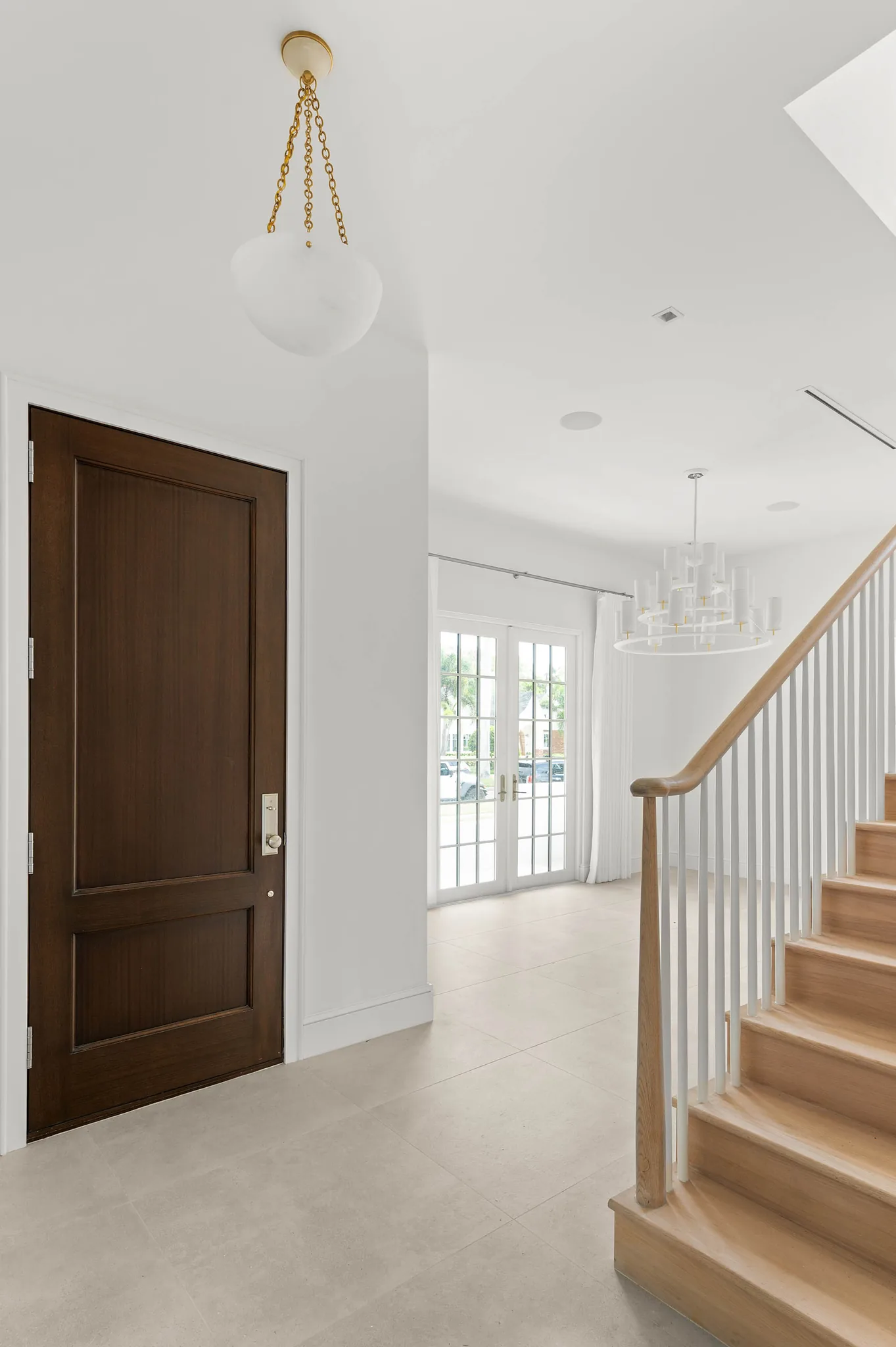 Entry foyer with mahogany front door and white oak staircase
