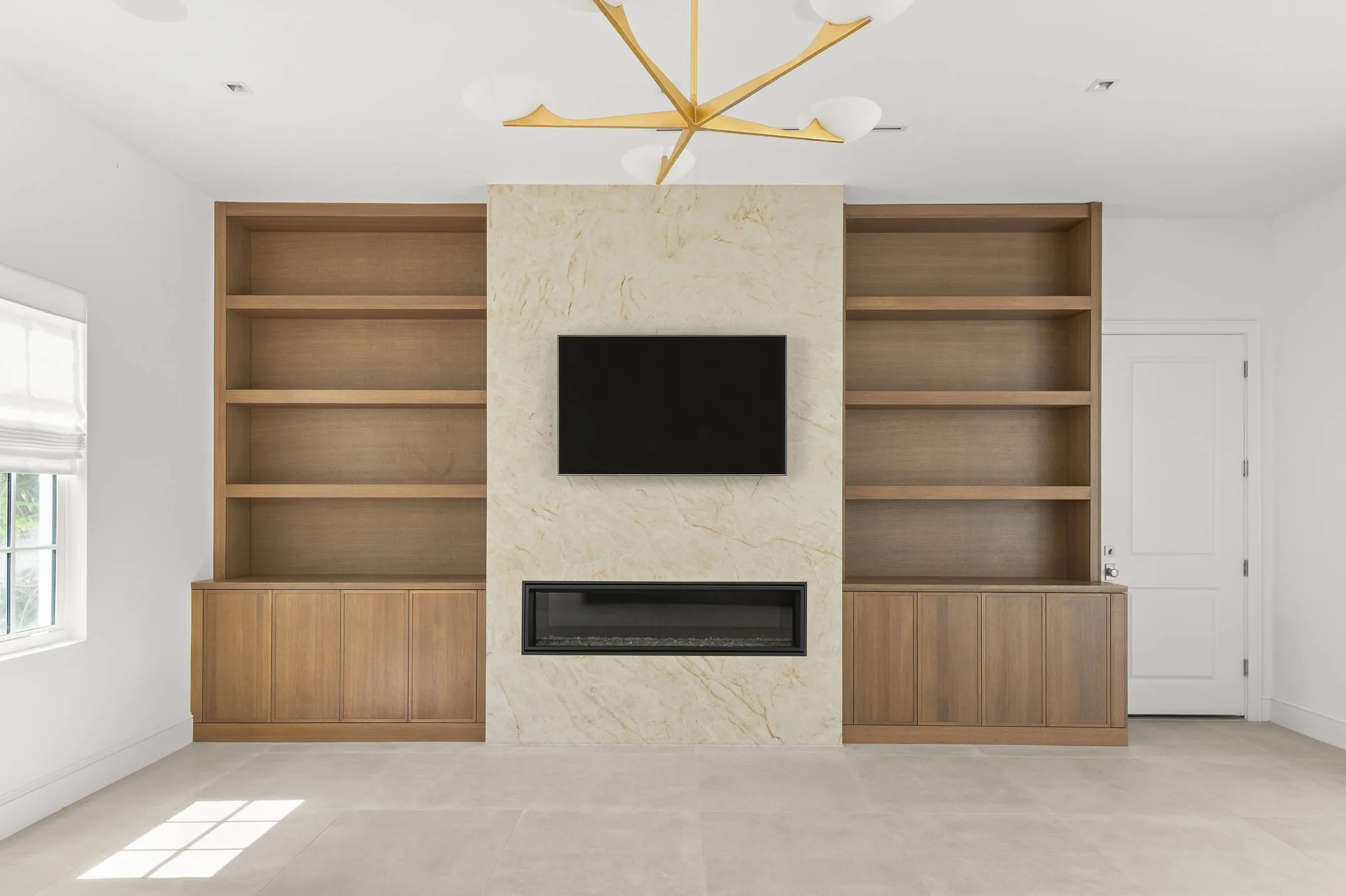 Great room with quartzite fireplace wall and white oak built-ins