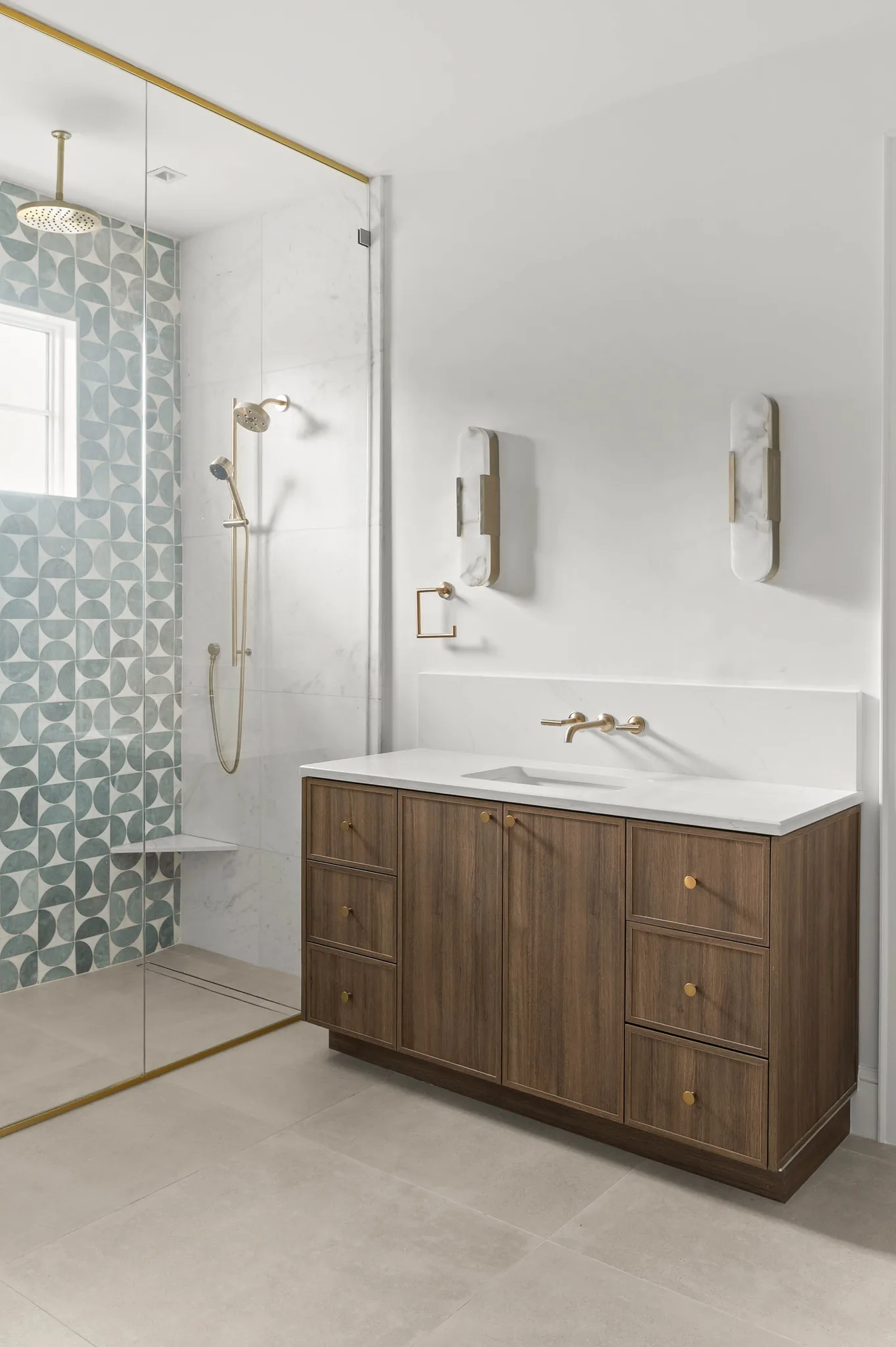 Primary shower with sage fan-tile accent wall and brass rain head